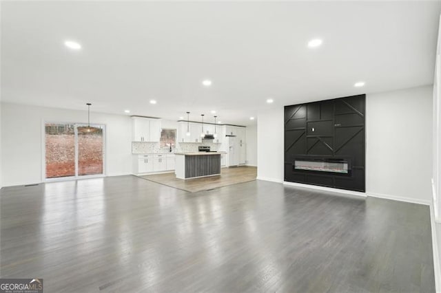 unfurnished living room with dark hardwood / wood-style floors and a fireplace