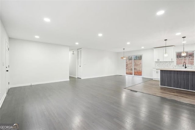 unfurnished living room featuring dark wood-type flooring