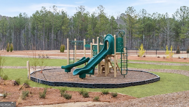 view of playground with a lawn