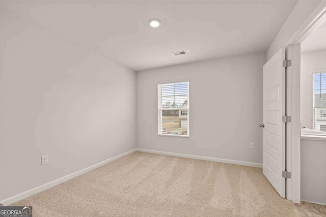 unfurnished bedroom with light colored carpet