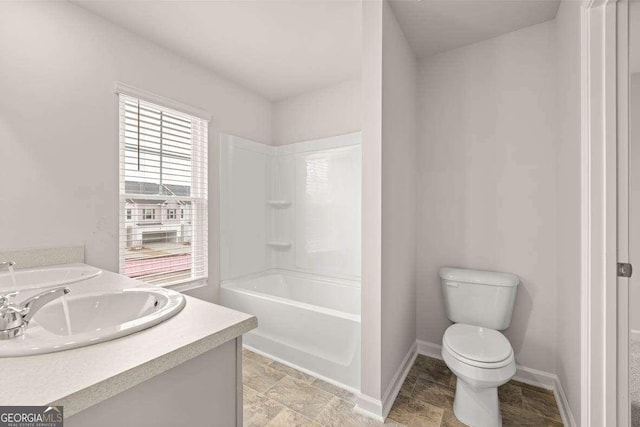 full bathroom with bathing tub / shower combination, toilet, and vanity