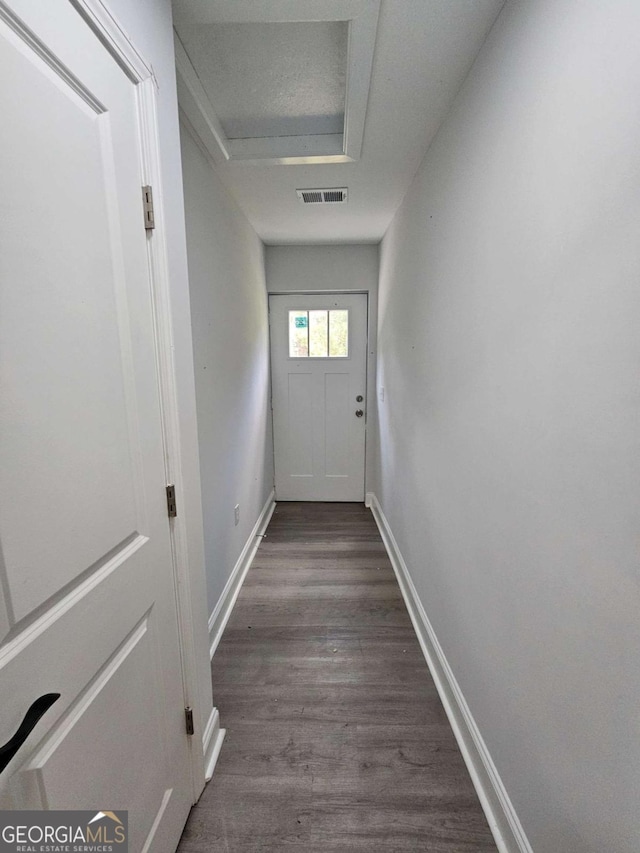 doorway with dark hardwood / wood-style floors