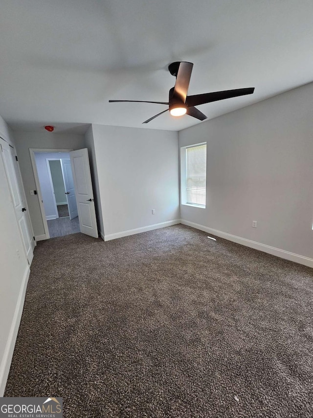 unfurnished room featuring carpet flooring and ceiling fan