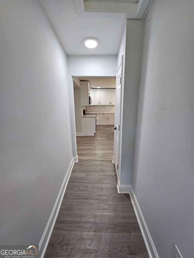 hallway with wood-type flooring