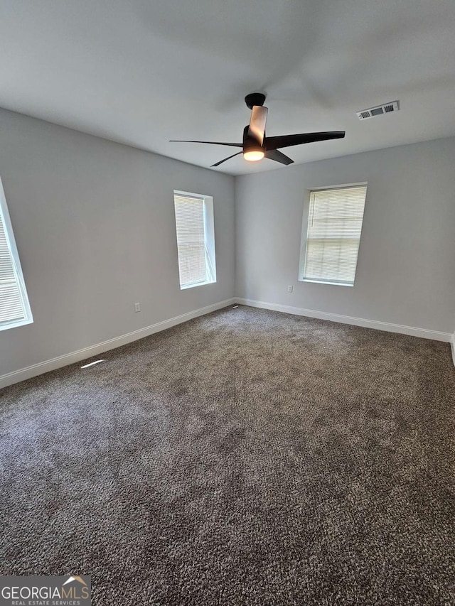 carpeted spare room with ceiling fan