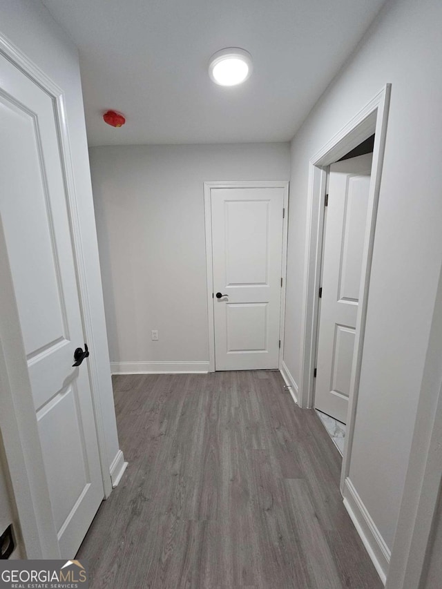 corridor with wood-type flooring