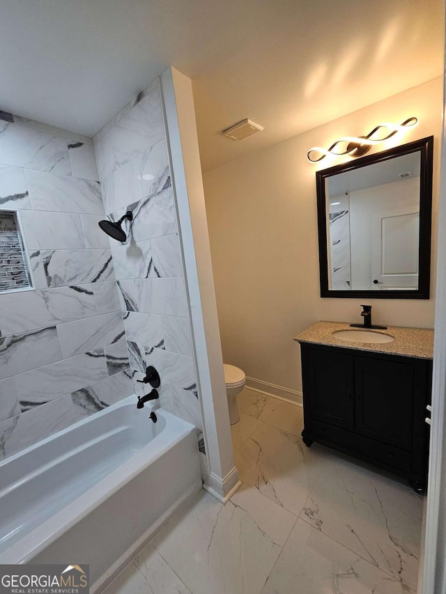 full bathroom featuring vanity, toilet, and tiled shower / bath