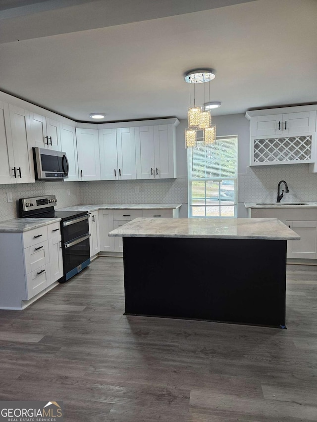1295 Ga Highway 49, Macon, GA 31211 - kitchen featuring a center island, decorative backsplash, stainless steel appliances, and dark wood-style flooring