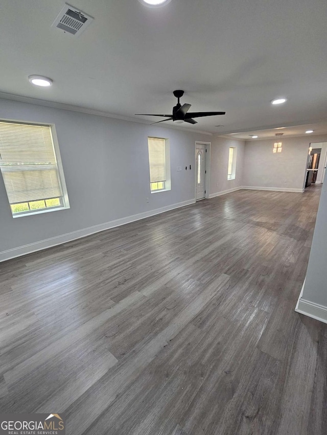 unfurnished room with ceiling fan, plenty of natural light, and dark hardwood / wood-style floors