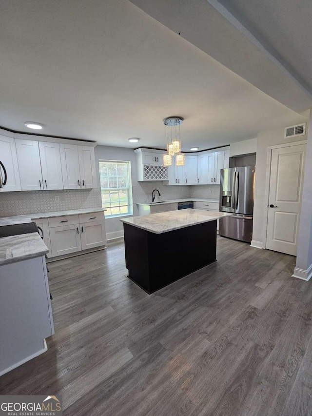 kitchen with pendant lighting, dark wood-type flooring, white cabinetry, a kitchen island, and stainless steel fridge with ice dispenser