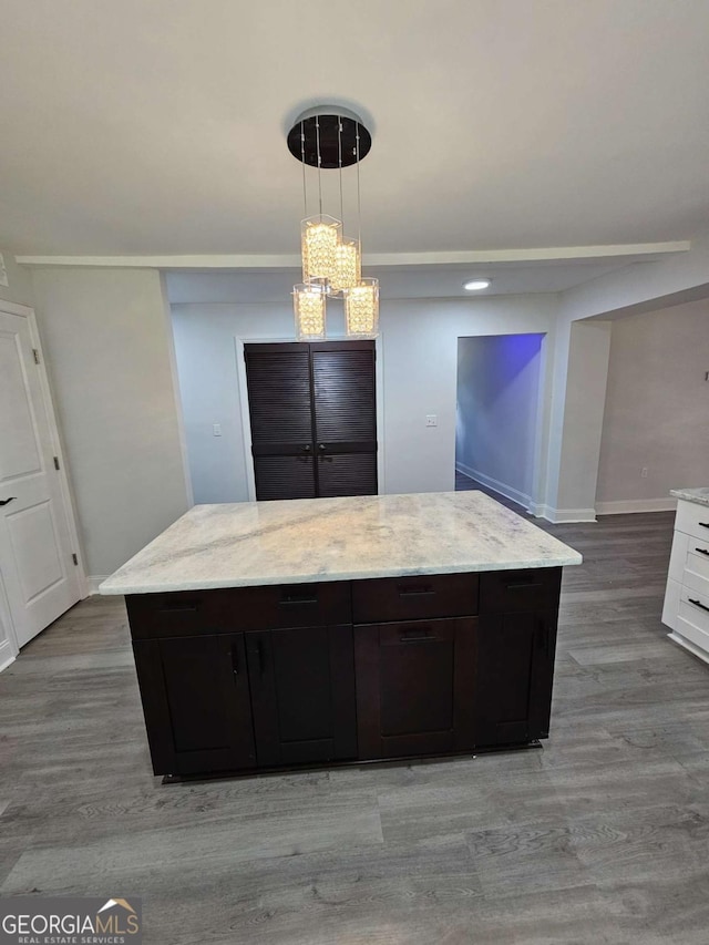 kitchen featuring dark brown cabinetry, white cabinetry, pendant lighting, and light wood-type flooring