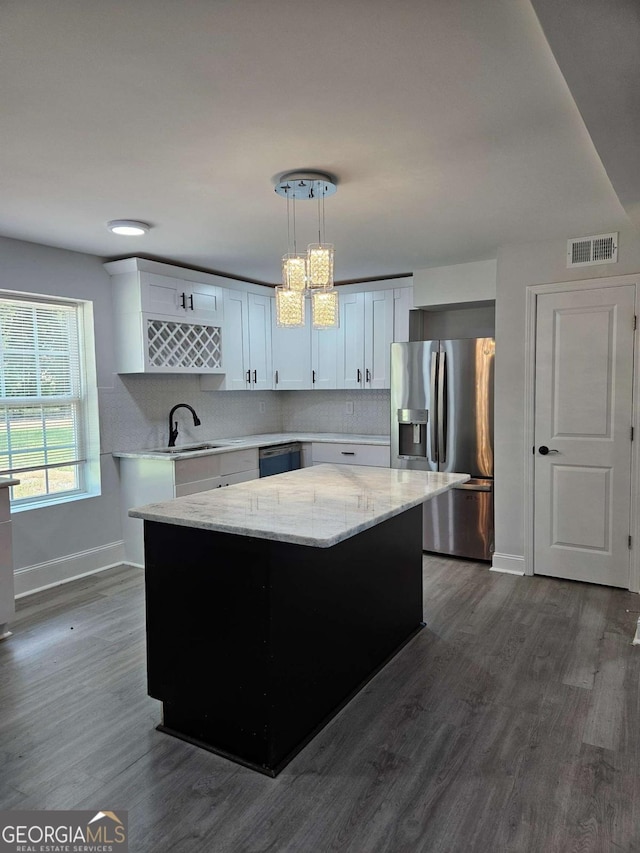 kitchen featuring sink, white cabinetry, hanging light fixtures, a center island, and stainless steel fridge with ice dispenser