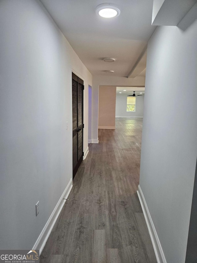 hall with dark wood-type flooring