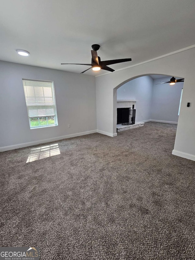 unfurnished living room featuring ceiling fan and carpet floors