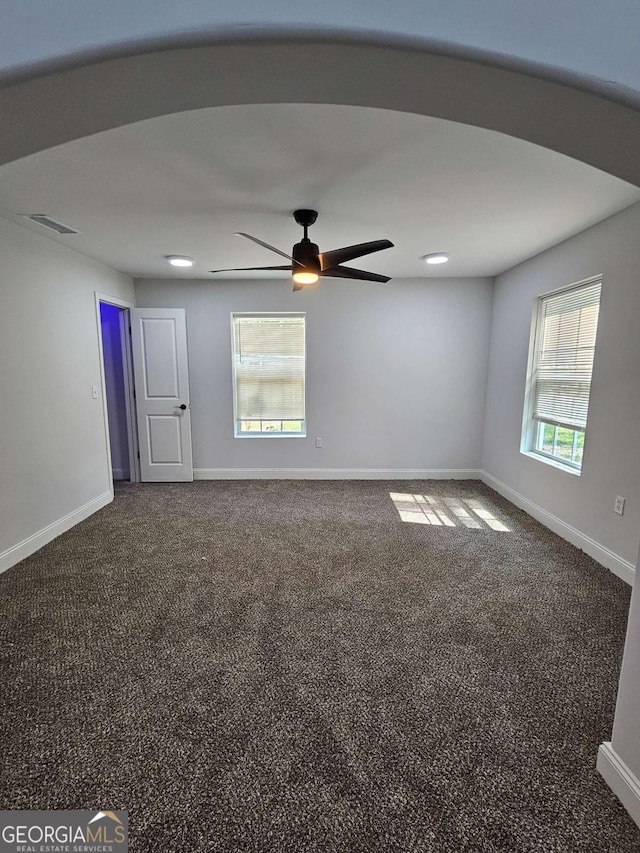 spare room featuring carpet floors and ceiling fan