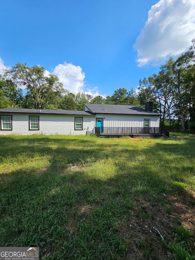 rear view of house with a yard