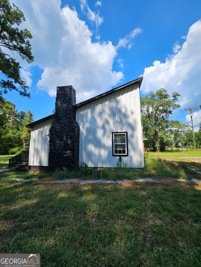 view of side of home featuring a lawn