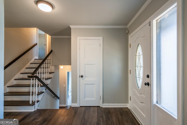 entrance foyer featuring ornamental molding and dark hardwood / wood-style floors