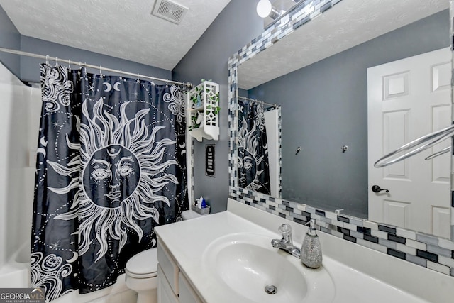 bathroom featuring vanity, a shower with curtain, toilet, and a textured ceiling