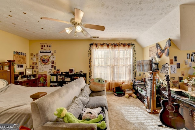 bedroom with ceiling fan, lofted ceiling, carpet floors, and a textured ceiling