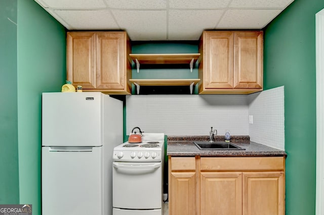 kitchen featuring tasteful backsplash, sink, white appliances, and a drop ceiling