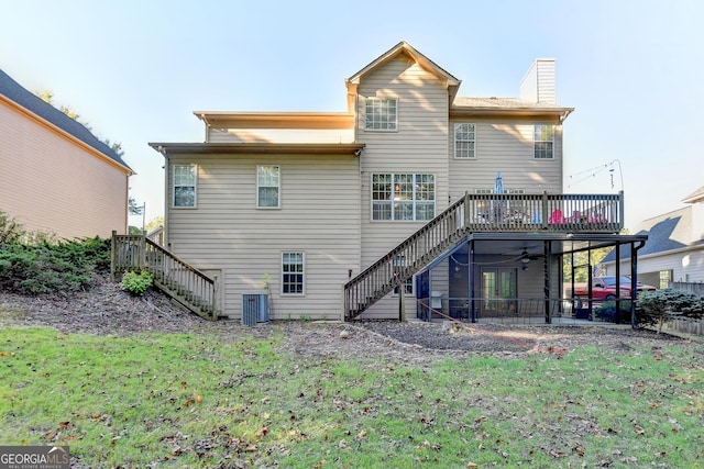 back of property with a wooden deck, a lawn, ceiling fan, and central air condition unit