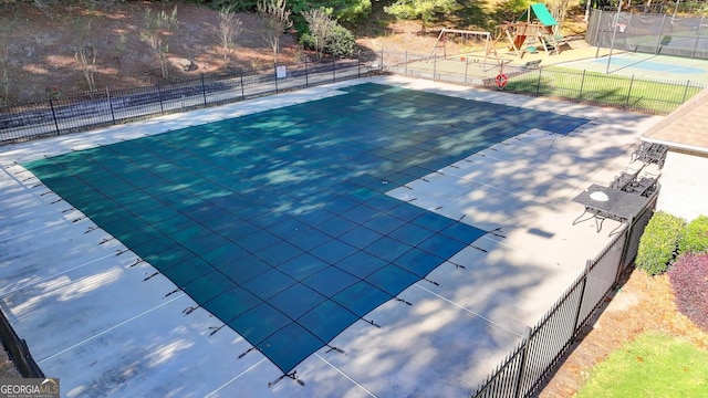 view of pool featuring a playground