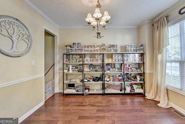 dining area featuring hardwood / wood-style flooring, crown molding, and a chandelier