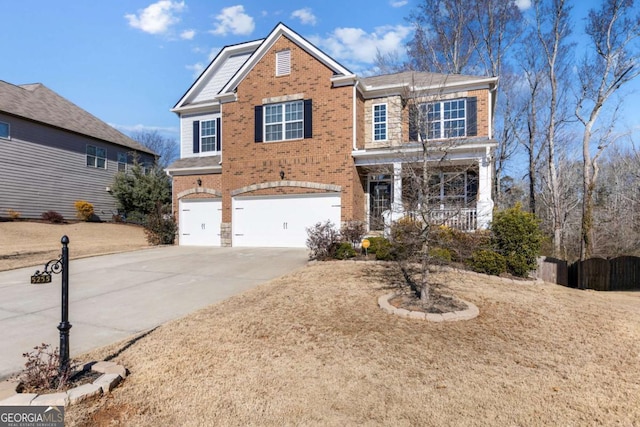 traditional-style house featuring an attached garage, concrete driveway, and brick siding