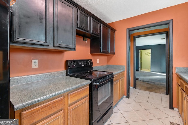 kitchen with light tile patterned floors and black / electric stove