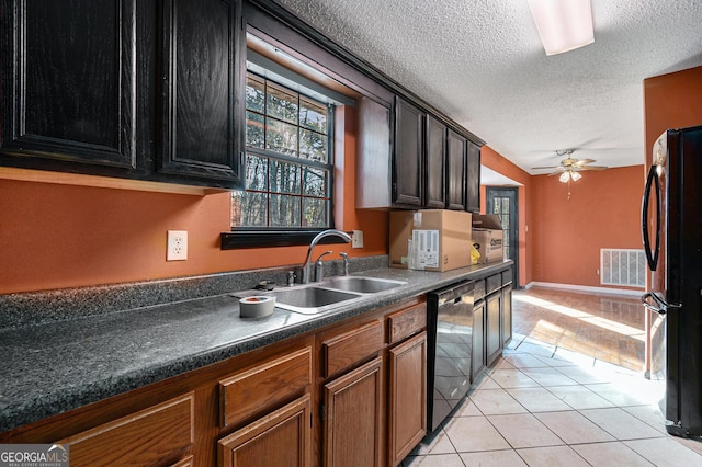 kitchen with sink, light tile patterned floors, ceiling fan, black appliances, and a textured ceiling