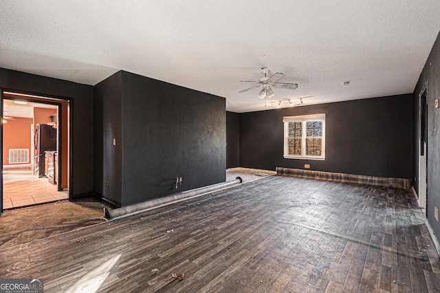 unfurnished room featuring hardwood / wood-style floors, a textured ceiling, and ceiling fan