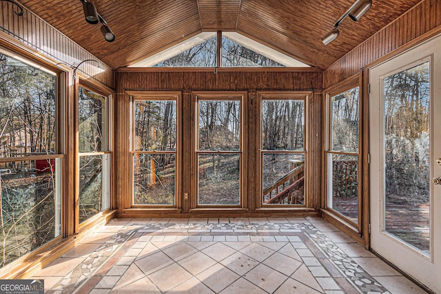 unfurnished sunroom featuring a healthy amount of sunlight, vaulted ceiling, and wooden ceiling