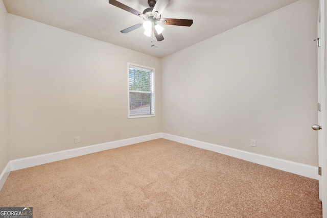 carpeted spare room featuring ceiling fan