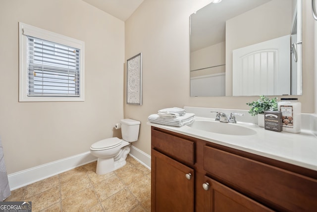 bathroom featuring vanity, tile patterned floors, and toilet