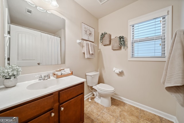 bathroom featuring vanity and toilet