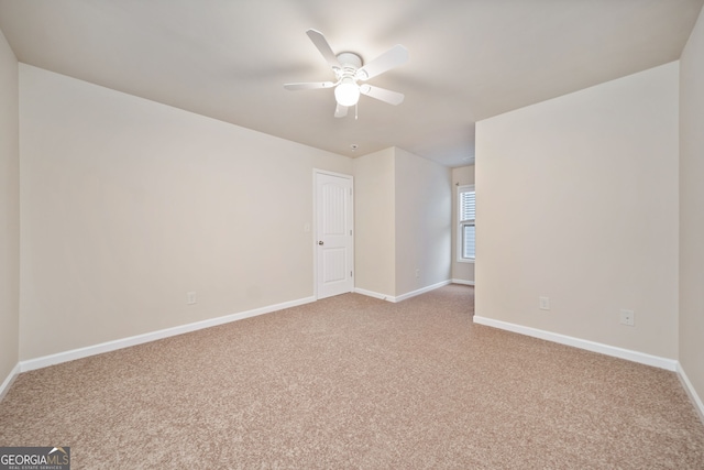 unfurnished room featuring light carpet and ceiling fan