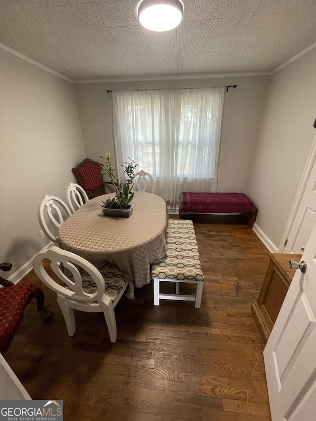 dining area featuring ornamental molding, dark hardwood / wood-style floors, and a textured ceiling