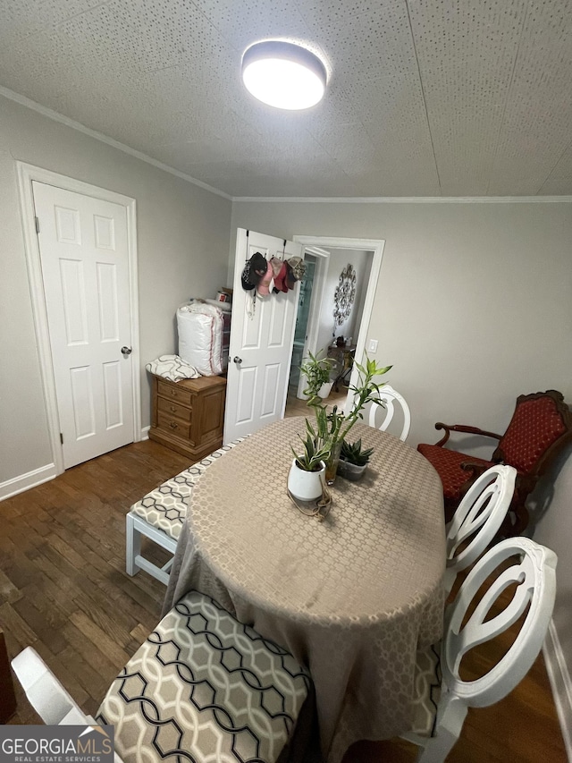 dining area featuring ornamental molding, dark hardwood / wood-style floors, and a textured ceiling