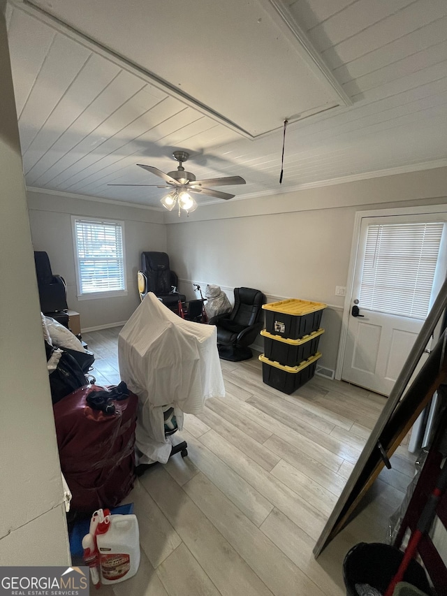 bedroom featuring ceiling fan, ornamental molding, and light wood-type flooring