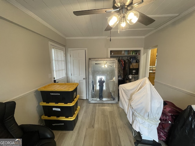 bedroom featuring ornamental molding, hardwood / wood-style floors, ceiling fan, and a closet