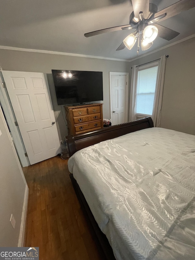 bedroom with crown molding, ceiling fan, and dark hardwood / wood-style flooring