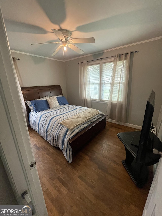 bedroom featuring ornamental molding, dark hardwood / wood-style floors, and ceiling fan