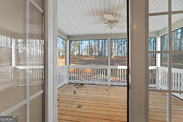 unfurnished sunroom featuring ceiling fan