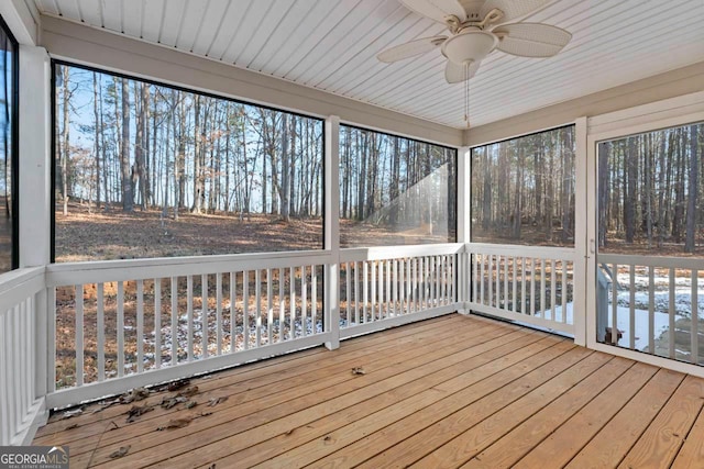 unfurnished sunroom with ceiling fan