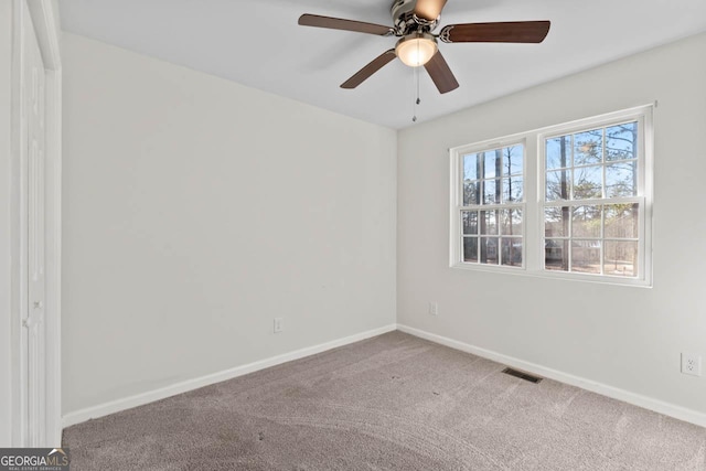 spare room with carpet flooring and ceiling fan