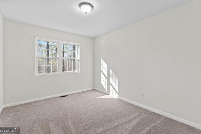 unfurnished room with light colored carpet