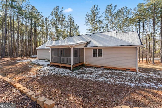 rear view of property with a sunroom