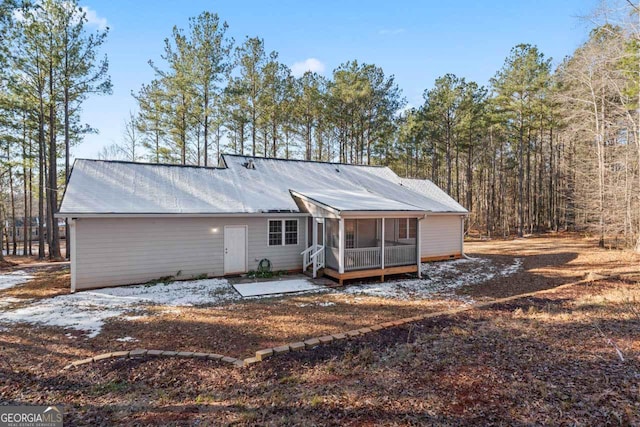 rear view of house with a patio area and a sunroom