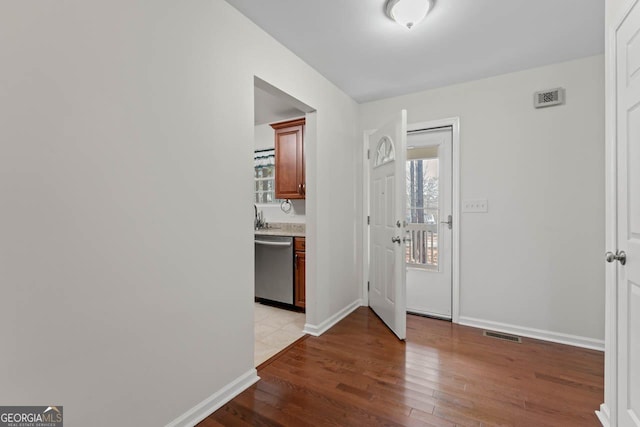 corridor with light hardwood / wood-style floors